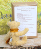 Bananaby sitting in front of and reading the back of the Bananaby Teddy Bear kit box which lists the contents