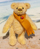 Bananaby standing up, he has joints in his limbs so that they move, he can sit down, stand up, wave and look from side to side and even over his back