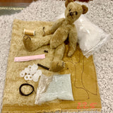 The kit includes , mohair with the pattern drawn out ready for cutting out, DMC black perle thread with a darning/ doll maker’s needle for embroidering the nose and mouth and inserting the eyes, plastic joints, polyester stuffing, glass beads and extra strong thread. A small sketchers soft water soluble pencil.