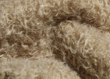 Clootie, 24 mm (nearly one inch) blond, dense, distressed mohair/viscose mix for teddy bears with a pale beige backing Clootie is a little different from out other materials, the pile is a mixture of mohair and viscose giving it a slight lustre. It has an intensely distressed tangled, blond/pale beige pile which is 24 mm (nearly) 1 inch long. It's a great colour and texture for medium and large traditional teddy bears, it's a proper 'teddy bear' colour.