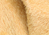 Golden Cracker 12 mm quite sparse, distressed (ratinee) mohair for teddy bears with a golden pile and warm beige backing This has a moderately short, distressed, fairy sparse, golden pile and a warm beige backing, which helps make your bear's face stand out.  It's a great colour for smaller traditional teddy bears, or larger bears that you want to look old and loved.