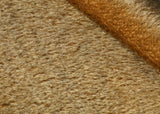 Singed Muffin 11 mm quite sparse, straight pile, mohair for teddy bears with a warm antique gold pile with black threads and an antique gold backing