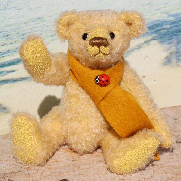 Bananaby mohair teddy bear kit makes a 7.5 inch pale yellow mohair teddy bear. It contains thorough instruction, lovely pale yellow German mohair with the pattern drawn out on it, polyester stuffing and some glass beads to add weight, felt scarf and a decorative bead. The kit is nicely boxed so you can give it as a gift