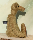 Profile of Hank teddy bear made from the Hank Mohair Heirloom Teddy Bear Kit. Showing his long nose, hands and feet and his big tummy 