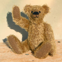 Mainwaring sitting down and waving, a bear made from the Mainwaring Mohair Teddy Bear Kit. A jointed teddy bear kit in brown mohair by Make A Teddy to make an 8 inch/20 cm teddy bear.