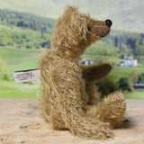 Mainwaring sitting down in profile, a bear made from the Mainwaring Mohair Teddy Bear Kit. A jointed teddy bear kit in brown mohair by Make A Teddy to make an 8 inch/20 cm teddy bear.