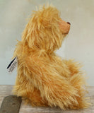 Profiie of Podgerson teddy bear made from the Podgerson teddy bear kit sitting on a wooden surface 