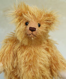 Close up of Podgerson teddy bear made from the Podgerson teddy bear kit sitting on a wooden surface 