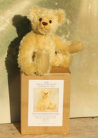 Sandy Teddy Bear Kit by Make A Teddy, showing our Sandy teddy bear in beautiful gold mohair sitting on the box containing the teddy bear kit