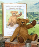 Treacle teddy bear kit by Make A Teddy, with teddy bear and packaging on a wooden surface with a scenic background