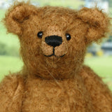 Close-up of a Treacle's face, a brown teddy made from the Treacle teddy bear kit with a blurred background
