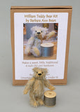 William standing next to a reel of thread and in front of his kit box. William Miniature Mohair Teddy Bear Kit. A jointed teddy bear kit by Make A Teddy to make a 4 inch/10 cm teddy bear.