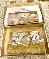 The inside of the box, showing the instructions, mohair, eyes, joints and thread.