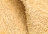 Golden Cracker 12 mm quite sparse, distressed (ratinee) mohair for teddy bears with a golden pile and warm beige backing This has a moderately short, distressed, fairy sparse, golden pile and a warm beige backing, which helps make your bear's face stand out.  It's a great colour for smaller traditional teddy bears, or larger bears that you want to look old and loved. 
